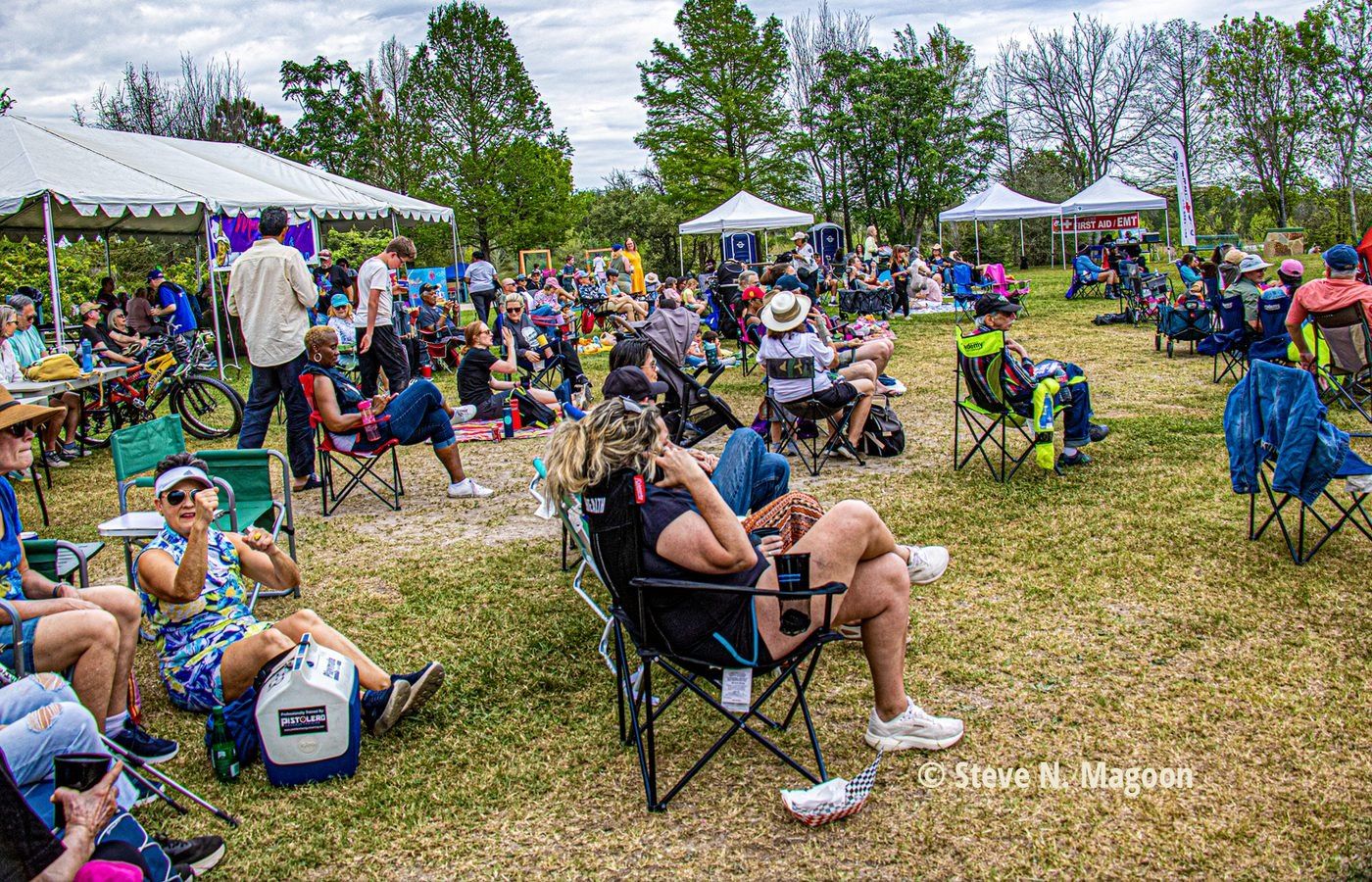 MusicFest crowd relaxing in lawn chairs under the trees at Willow Waterhole