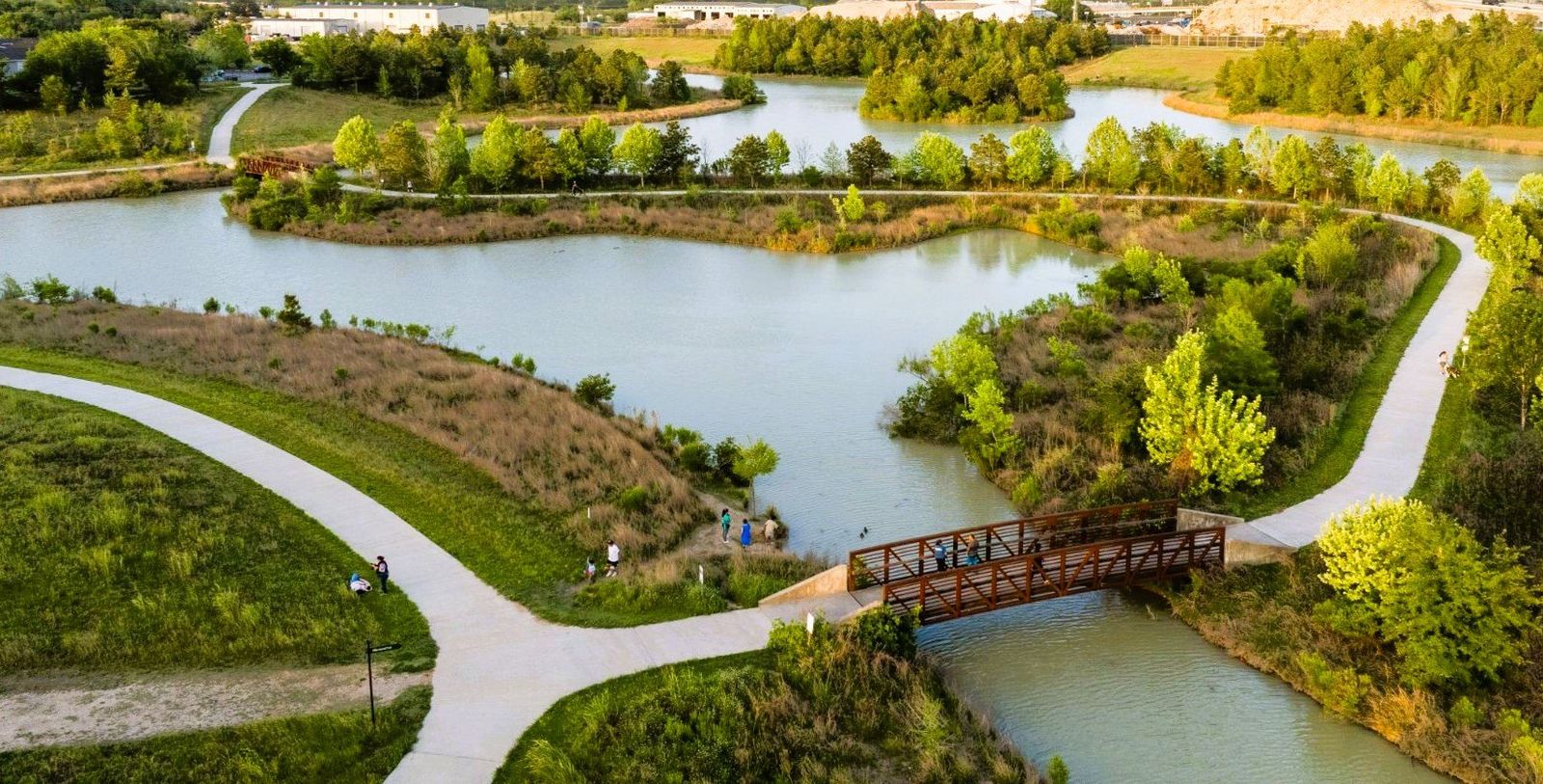 Aerial view of Willow Waterhole Greenway lakes, trails and a footbridge